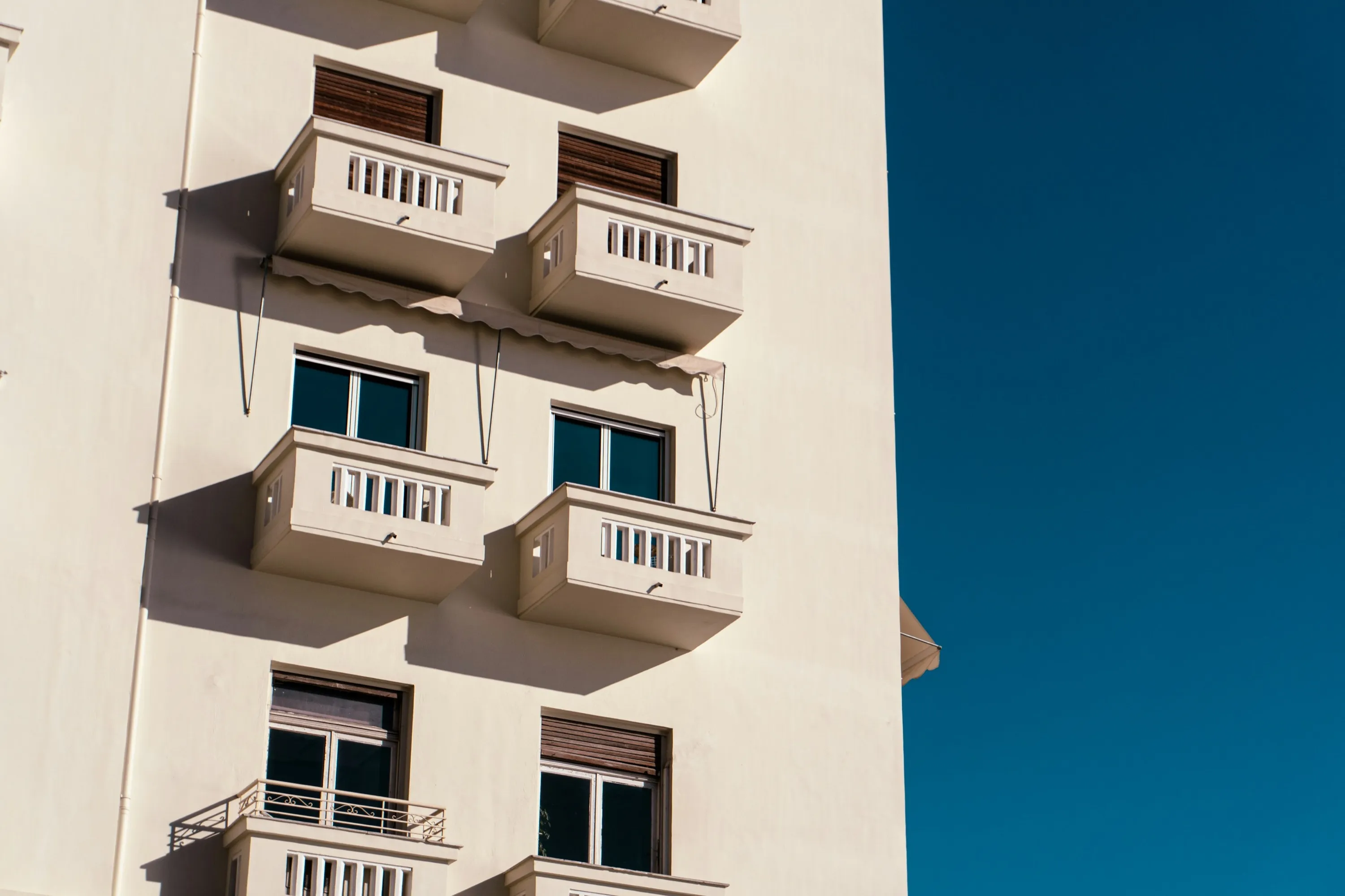 A long residential facade with regular balconies
