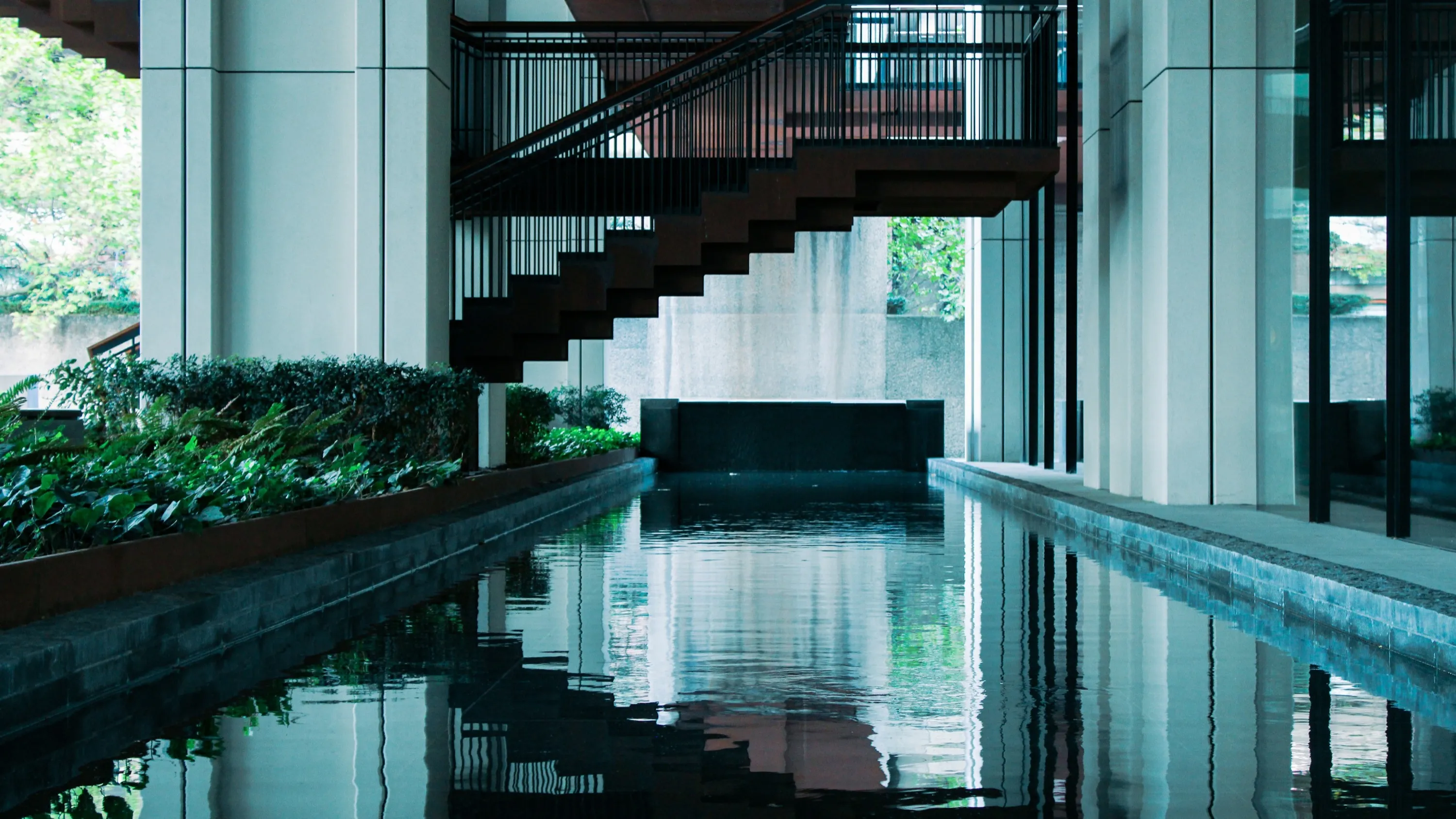 A long pool beside a residential complex